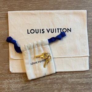 Louis Vuitton dust bad and set of keys.